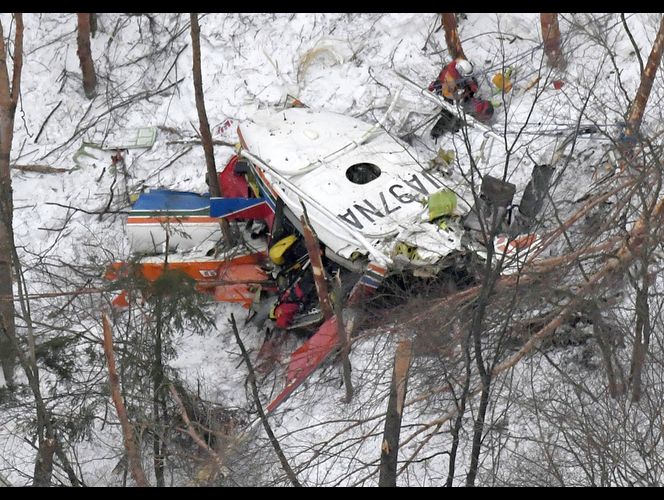 TOKYO (AP) — A rescue helicopter carrying nine people crashed in snow-covered mountains in central Japan during a training flight Sunday, leaving at least three people dead and four missing.