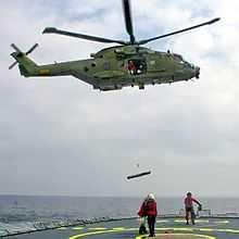 A Royal Danish Air Force AW101 hoisting from a ship's deck