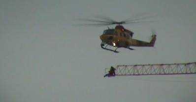 CH-146 Griffon rescue helicopter that arrived at the scene above Princess and Victoria streets before 4 p.m. Tuesday to reach the worker, who was trapped high in the air while fire crews worked to put out a blaze below.